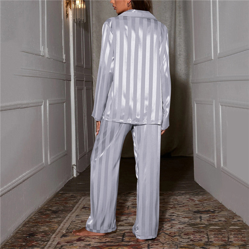 "Women's silk-feel pyjama set, front view: luxurious loungewear with button-down top, matching trousers, elegant sheen."