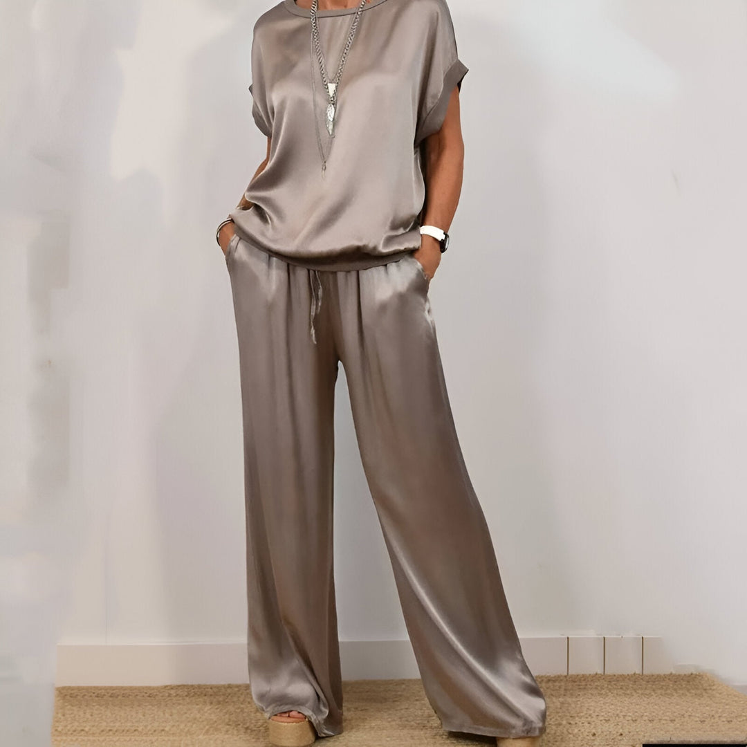 "Women's soft co-ord set with wide-leg trousers and short sleeve top in neutral hues, depicting elegance and comfort."
