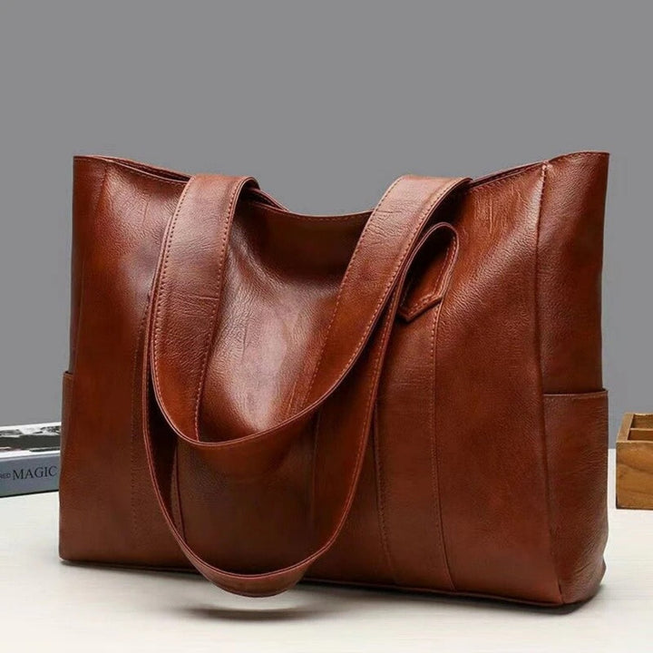 "Women's vintage leather shoulder bag, large capacity, sleek silhouette, elegant brown finish, perfect for daily use."