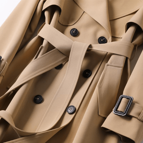 "Women's vintage trench coat with modern details, featuring a classic silhouette, defined waistline, and stylish accents."