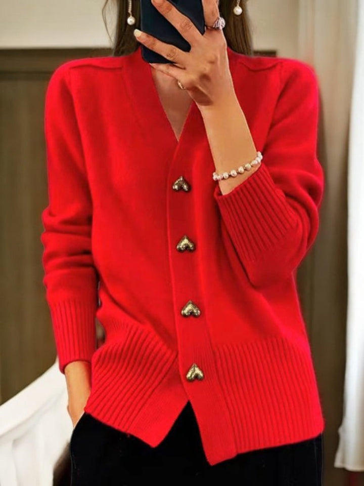 Women's wool cardigan in a solid color with button-up design, long sleeves, and hip-length perfect for winter warmth.