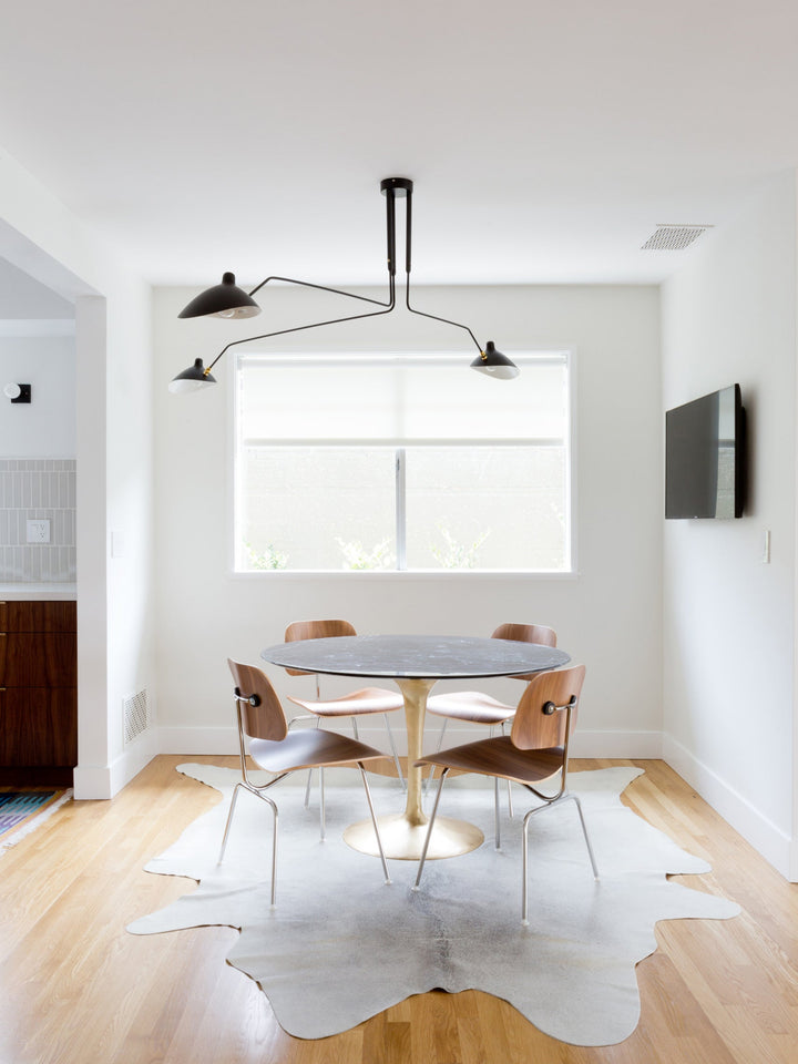 "Adjustable ceiling light with multiple arms, minimalist design, ideal for modern interiors, made of steel and aluminium."