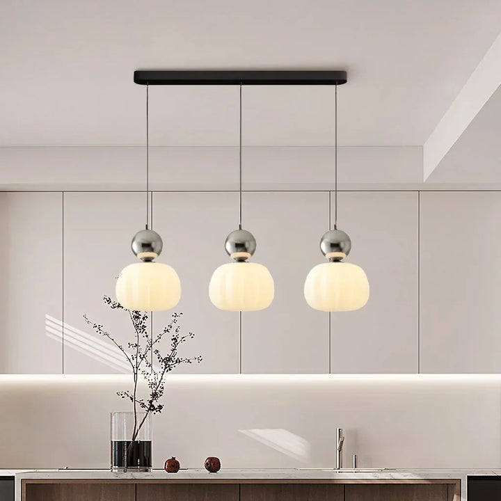 "Art Deco Cream Pendant Light with Bauhaus design, features high-quality metal frame and warm glow for elegant home lighting.
