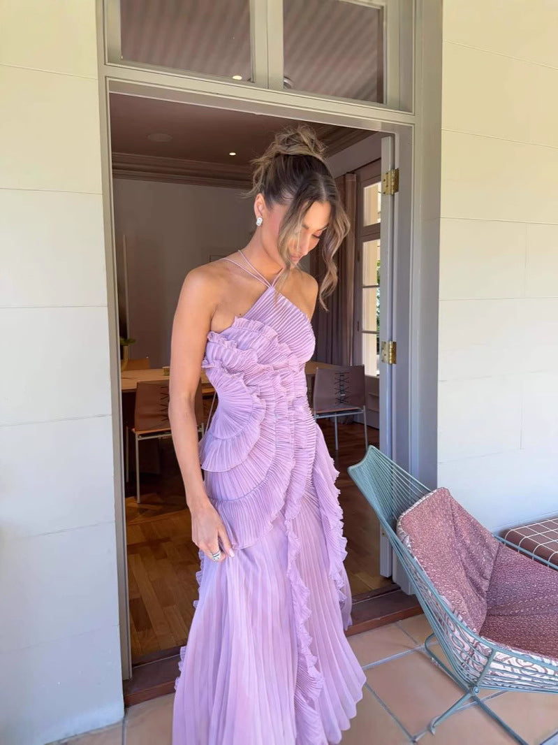 Asymmetric pleated ruffle maxi dress with halter neck, side view; elegant flowy design for special occasions.
