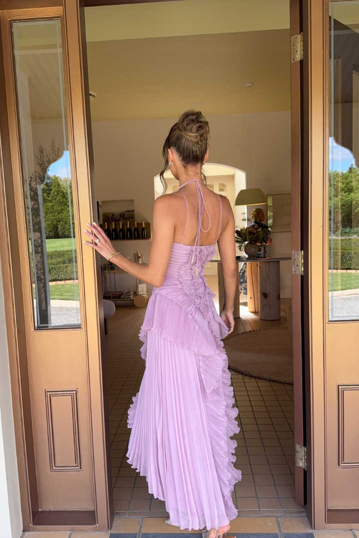Asymmetric pleated ruffle maxi dress with halter neck, side view; elegant flowy design for special occasions.