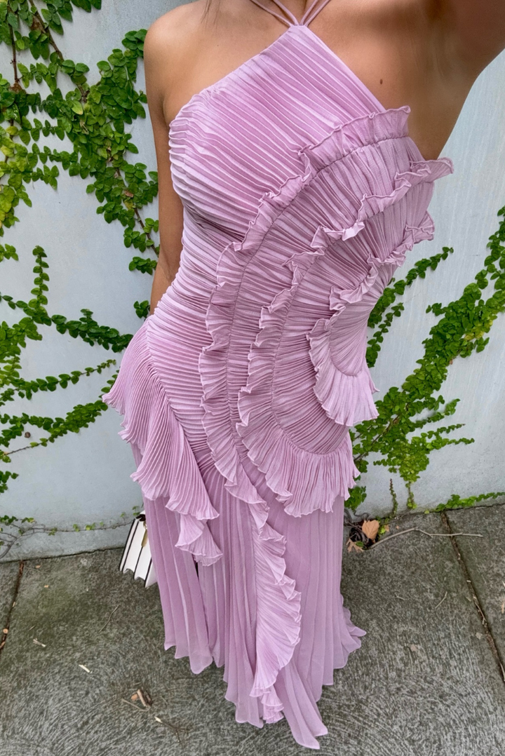 Asymmetric pleated ruffle maxi dress with halter neck, side view; elegant flowy design for special occasions.