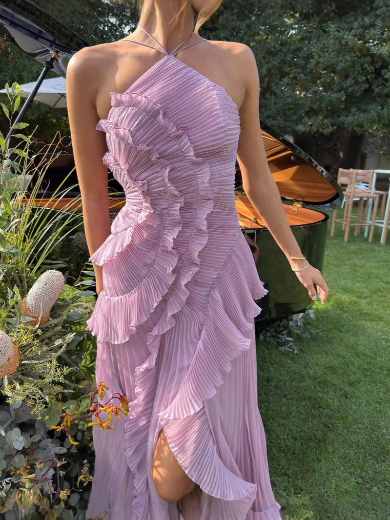 Asymmetric pleated ruffle maxi dress with halter neck, side view; elegant flowy design for special occasions.