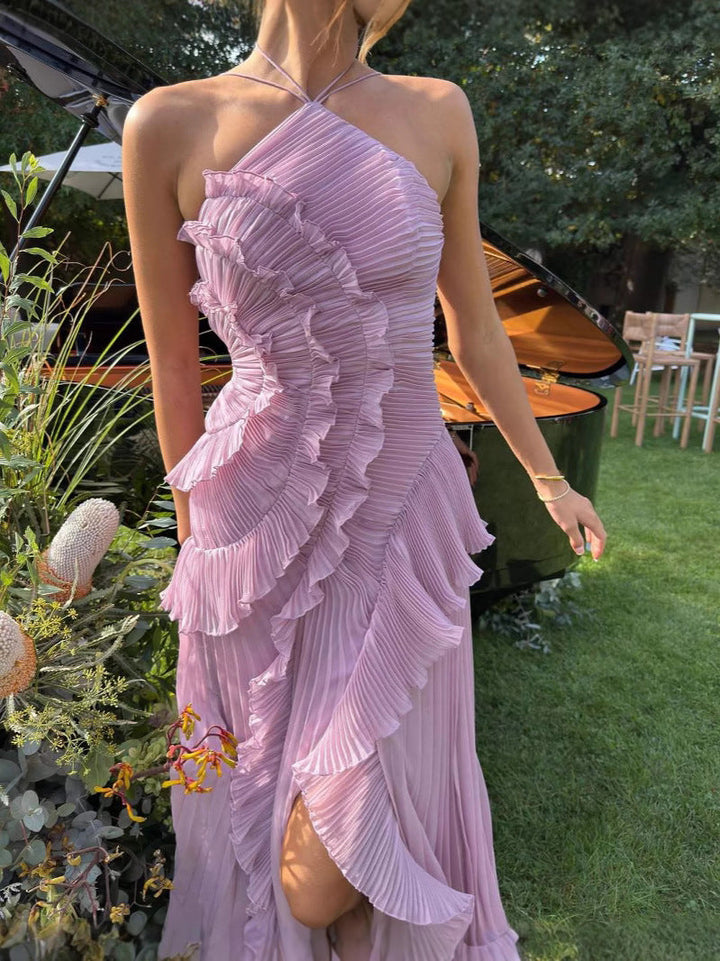 Asymmetric pleated ruffle maxi dress with halter neck, side view; elegant flowy design for special occasions.