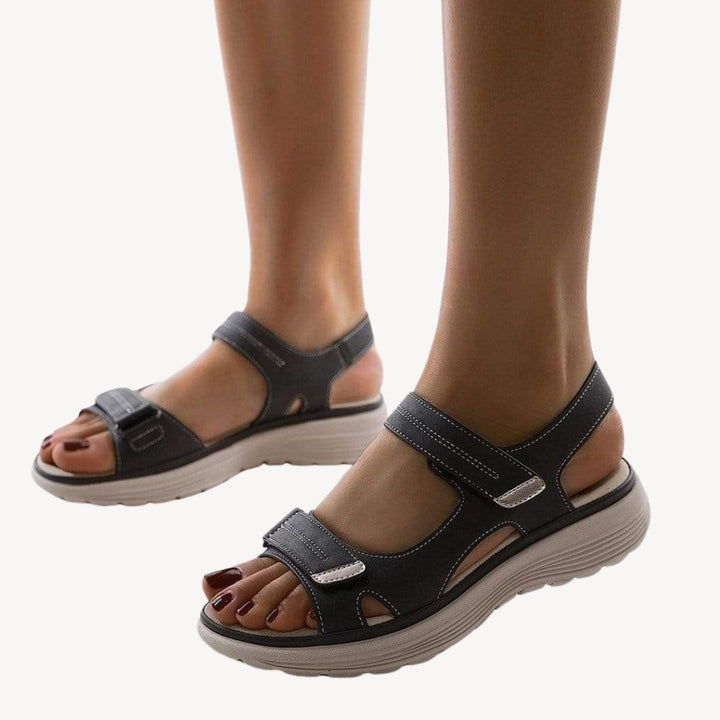 "Beige orthopedic sandals with adjustable straps and arch support, featuring a cushioned shock-absorbing sole."