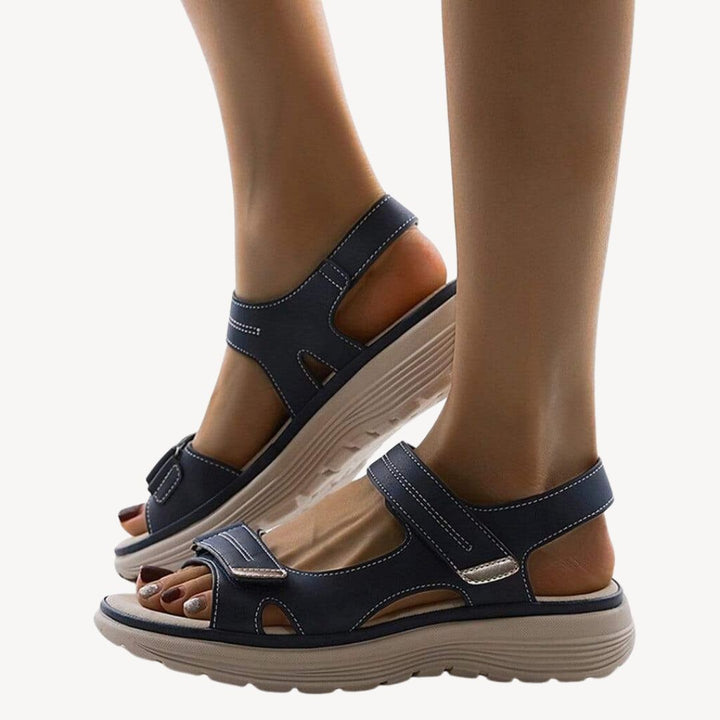 "Beige orthopedic sandals with adjustable straps and arch support, featuring a cushioned shock-absorbing sole."