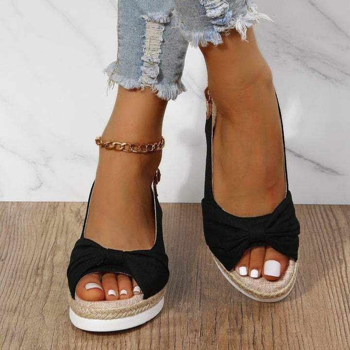 Beige women's wedge sandals with chic knot detail, open toe, slingback strap, and braided jute platform for summer style.