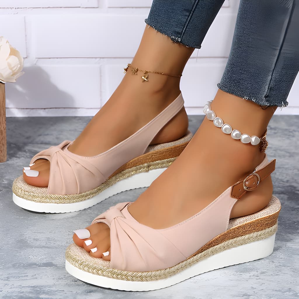 Beige women's wedge sandals with chic knot detail, open toe, slingback strap, and braided jute platform for summer style.