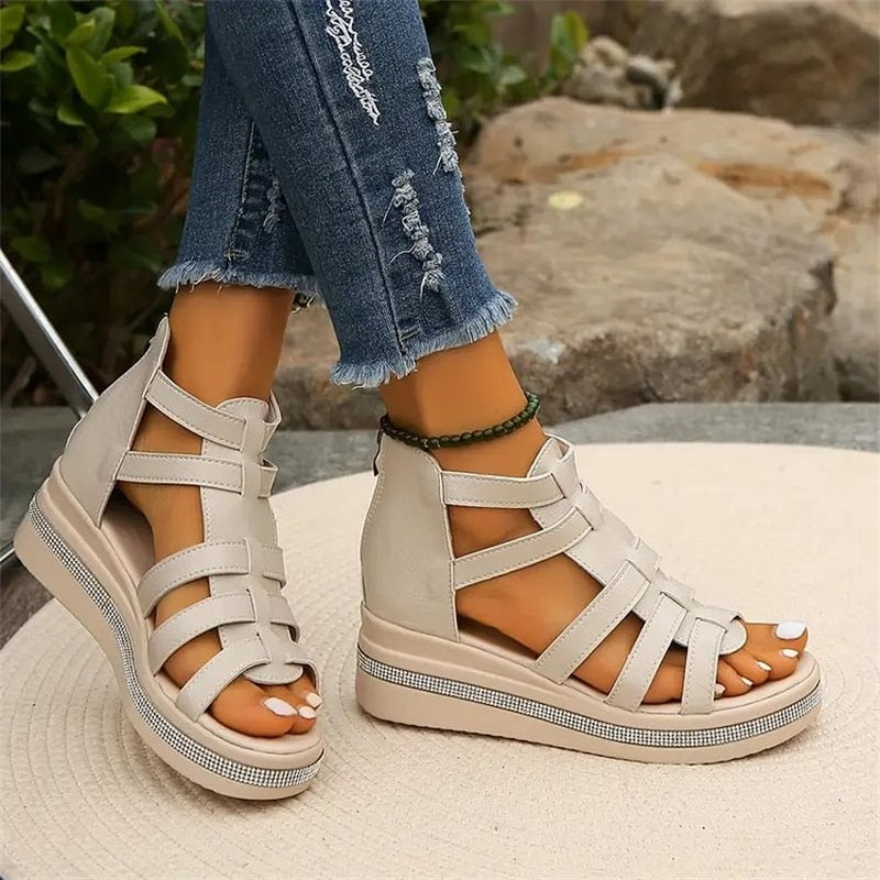 Beige women's wedge sandals with glittering rhinestone accents, offering elegant style and comfort for summer outings.