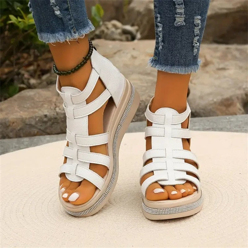 Beige women's wedge sandals with glittering rhinestone accents, offering elegant style and comfort for summer outings.
