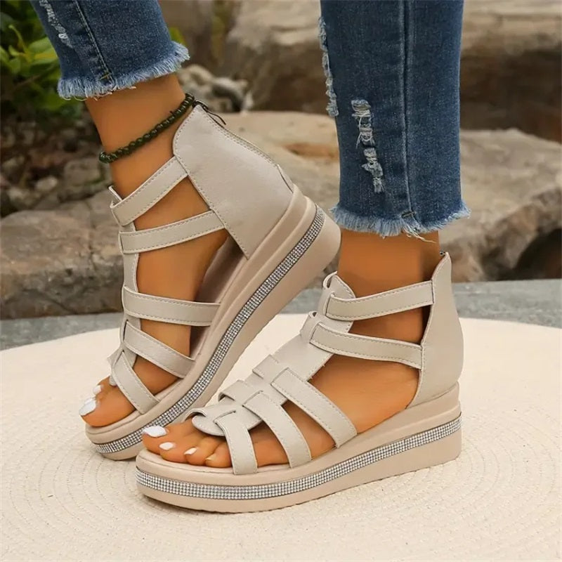 Beige women's wedge sandals with glittering rhinestone accents, offering elegant style and comfort for summer outings.