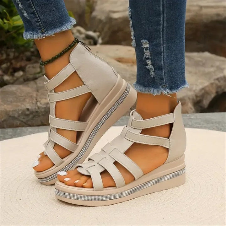 Beige women's wedge sandals with glittering rhinestone accents, offering elegant style and comfort for summer outings.