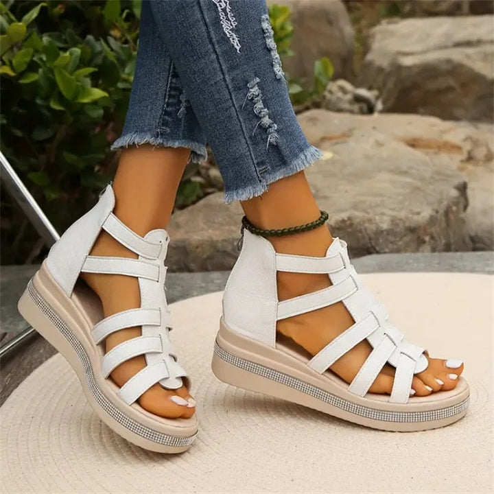Beige women's wedge sandals with glittering rhinestone accents, offering elegant style and comfort for summer outings.
