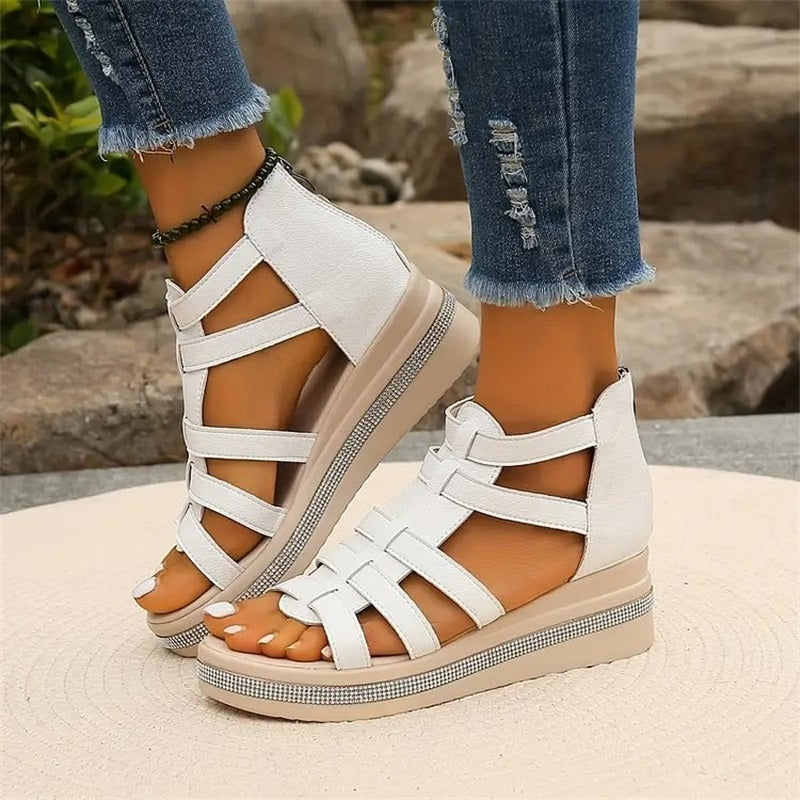 Beige women's wedge sandals with glittering rhinestone accents, offering elegant style and comfort for summer outings.
