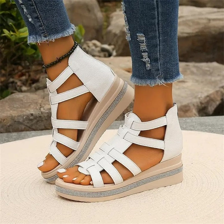 Beige women's wedge sandals with glittering rhinestone accents, offering elegant style and comfort for summer outings.