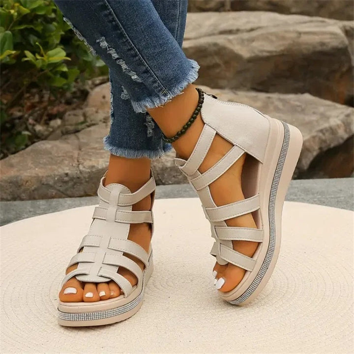 Beige women's wedge sandals with glittering rhinestone accents, offering elegant style and comfort for summer outings.