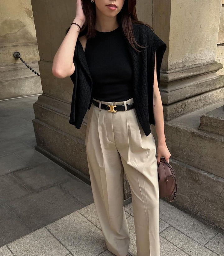 Black leather women's belt with a gold buckle, elegant and versatile for both casual and formal outfits, shown in detail.