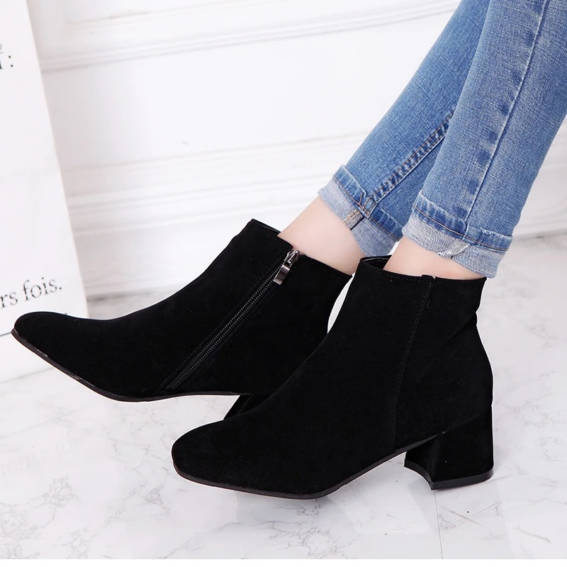 "Black suede women's ankle boots with side zip and low block heel, showcasing a stylish and comfortable design."