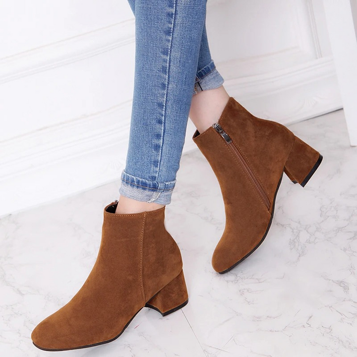"Black suede women's ankle boots with side zip and low block heel, showcasing a stylish and comfortable design."