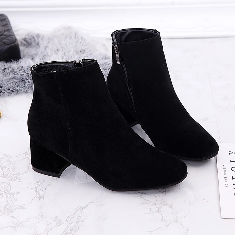 "Black suede women's ankle boots with side zip and low block heel, showcasing a stylish and comfortable design."