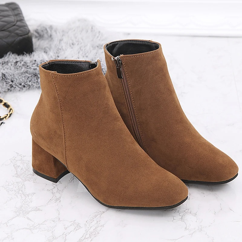 "Black suede women's ankle boots with side zip and low block heel, showcasing a stylish and comfortable design."