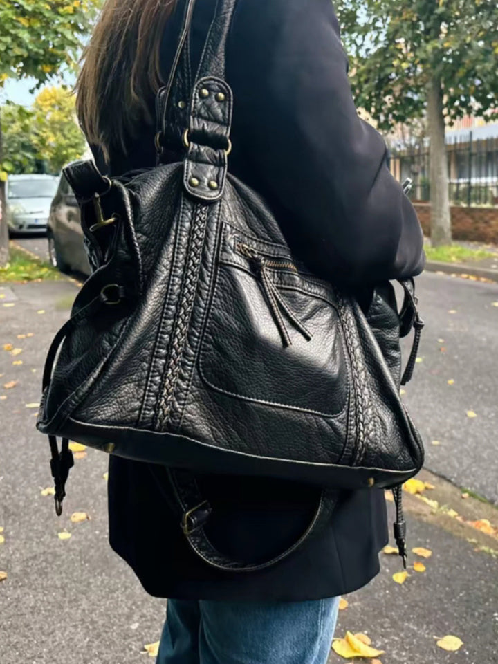 "Black vegan leather shoulder bag for women with elegant design, adjustable strap, and secure closures, perfect for daily use