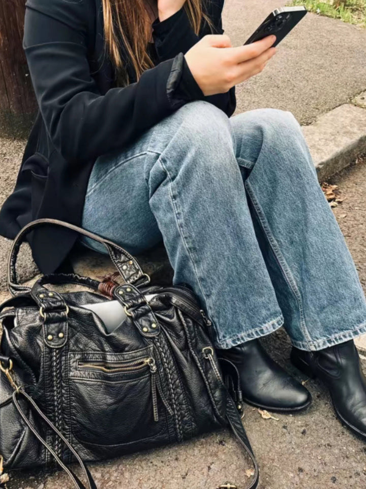 "Black vegan leather shoulder bag for women with elegant design, adjustable strap, and secure closures, perfect for daily use