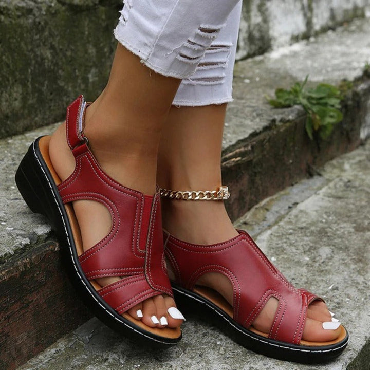 Black women's orthopedic sandals with arch support, soft sole, open-toe, Velcro strap, stylish comfort for daily wear.