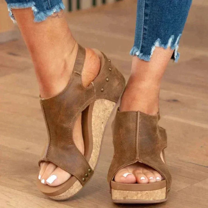 Black women's orthopedic wedge sandals with a cork midsole, faux leather upper, and secure hook-and-loop closure.