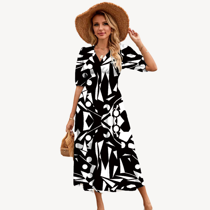 Blue floral print V-neck midi dress with tie waist, short puff sleeves, and flowing silhouette, ideal for elegant styles.