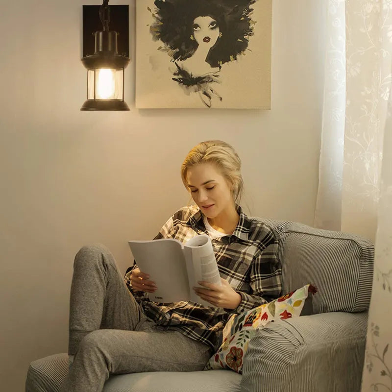 Bronze vintage industrial wall sconce lamp with oil-bronze finish and glass shade, perfect for living room lighting.