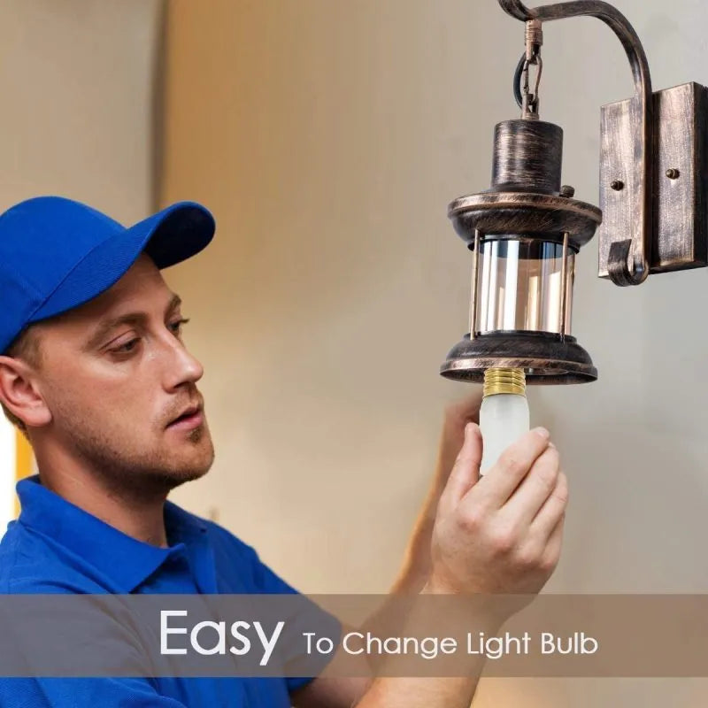 Bronze vintage industrial wall sconce lamp with oil-bronze finish and glass shade, perfect for living room lighting.