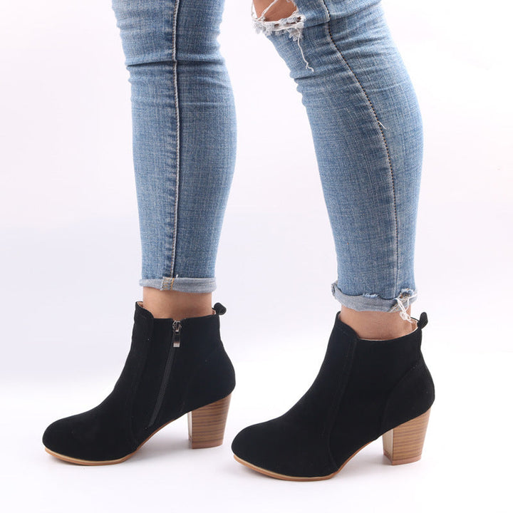 Burgundy women's suede ankle boots with chunky heel and side zip, showcasing stylish comfort and modern elegance.