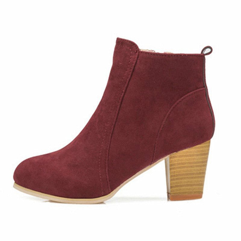 Burgundy women's suede ankle boots with chunky heel and side zip, showcasing stylish comfort and modern elegance.