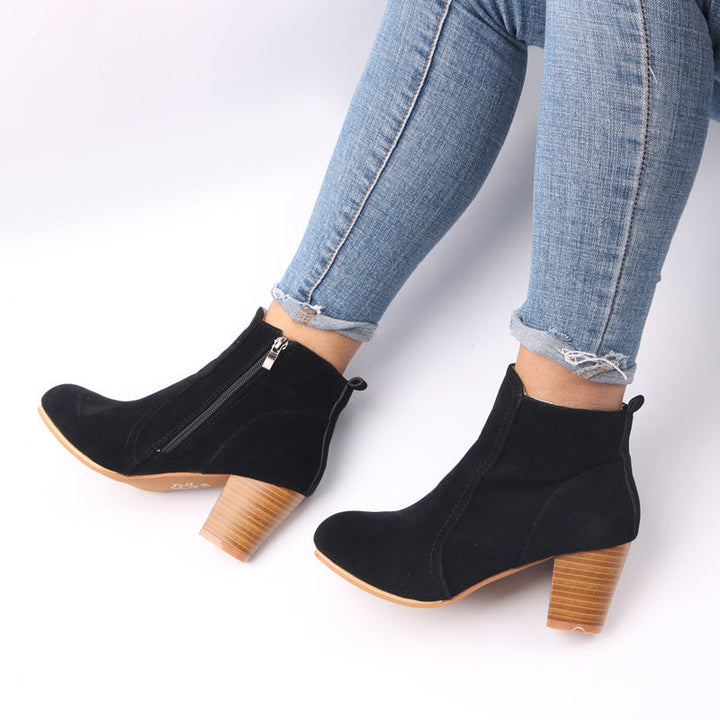 Burgundy women's suede ankle boots with chunky heel and side zip, showcasing stylish comfort and modern elegance.