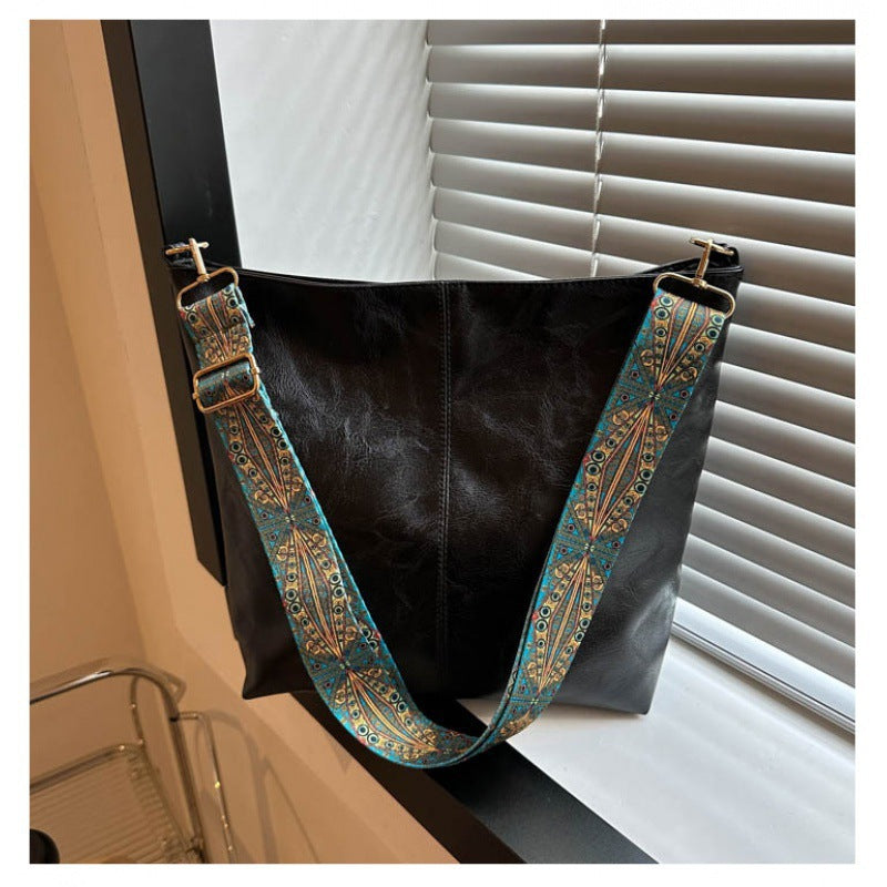 "Chic medium faux leather shoulder bag with embellished adjustable strap in black, caramel, green, or khaki for women."