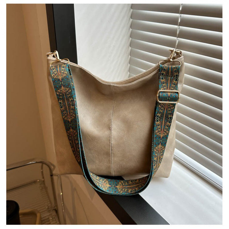 "Chic medium faux leather shoulder bag with embellished adjustable strap in black, caramel, green, or khaki for women."
