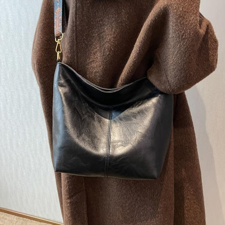 "Chic medium faux leather shoulder bag with embellished adjustable strap in black, caramel, green, or khaki for women."
