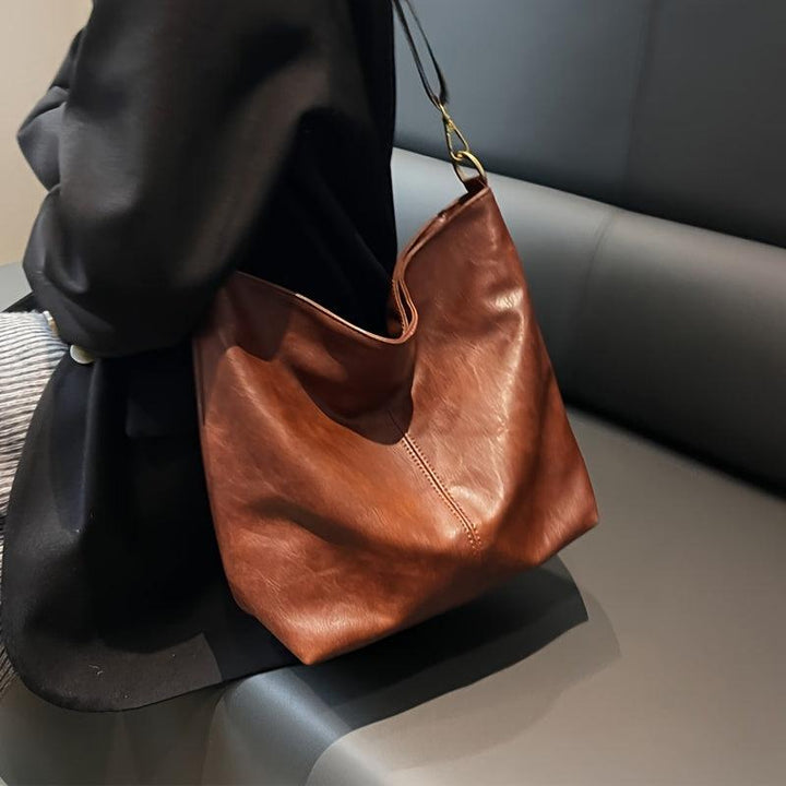 "Chic medium faux leather shoulder bag with embellished adjustable strap in black, caramel, green, or khaki for women."