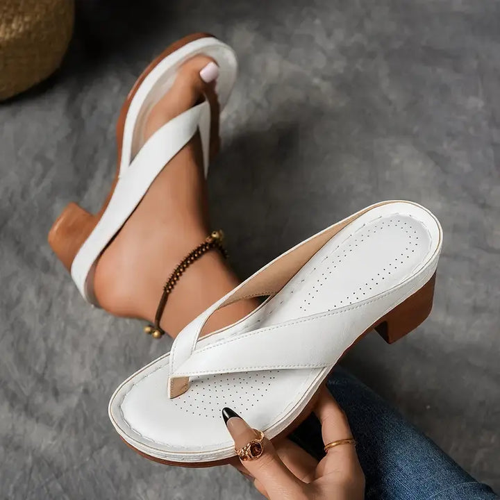 "Chic women's flip-flop sandals with platform heels, wide straps, open-toe design, in black, brown, gold, or white."
