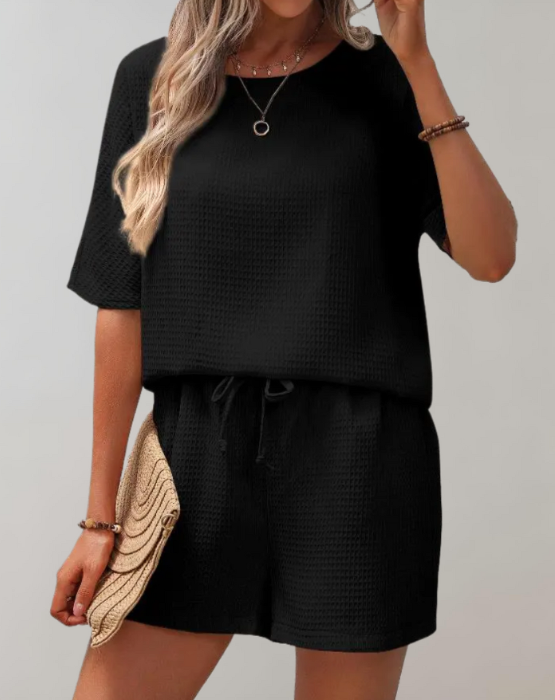 Chic women's two-piece set with a stylish top and loose-fit shorts, perfect for casual elegance and comfort.