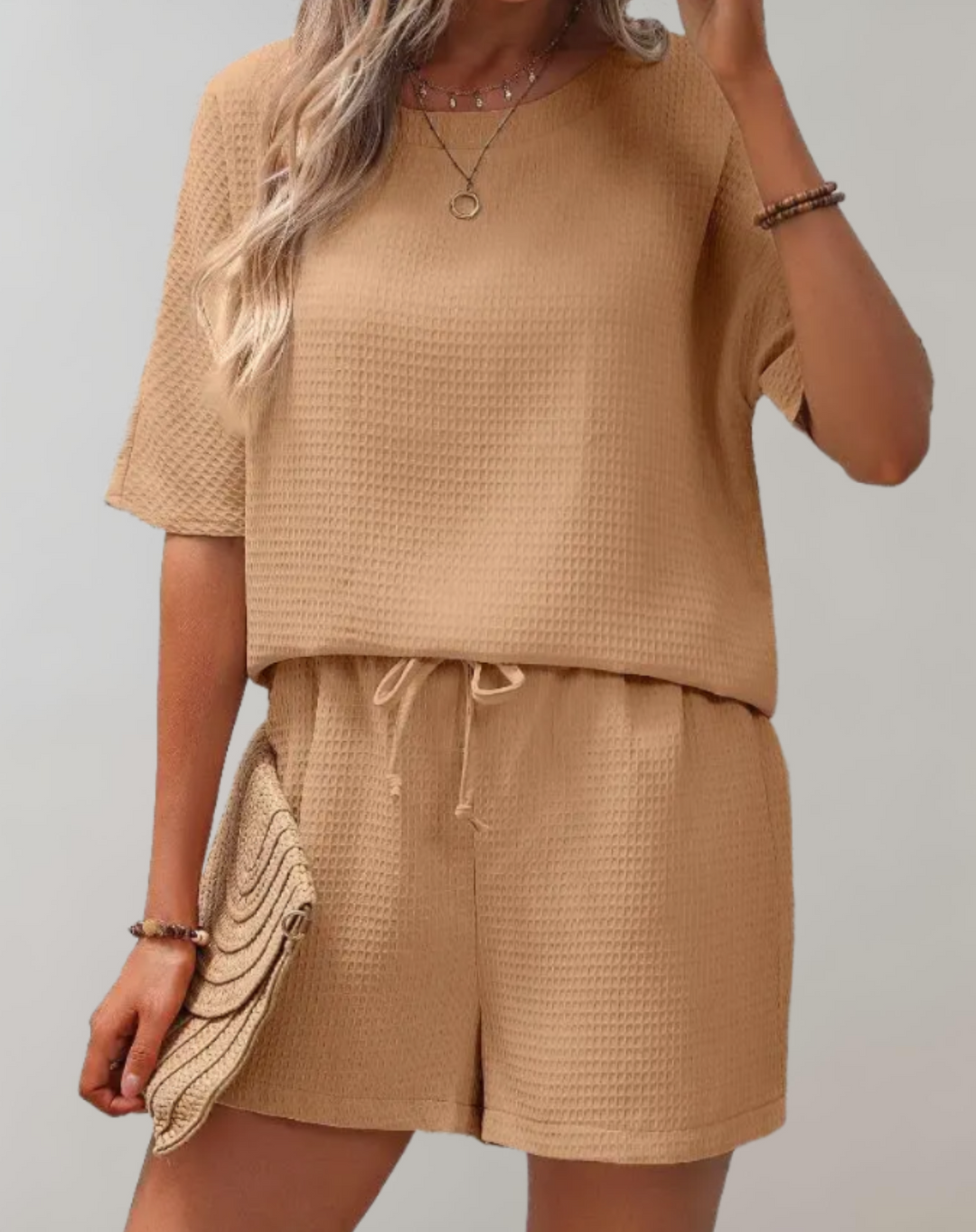 Chic women's two-piece set with a stylish top and loose-fit shorts, perfect for casual elegance and comfort.