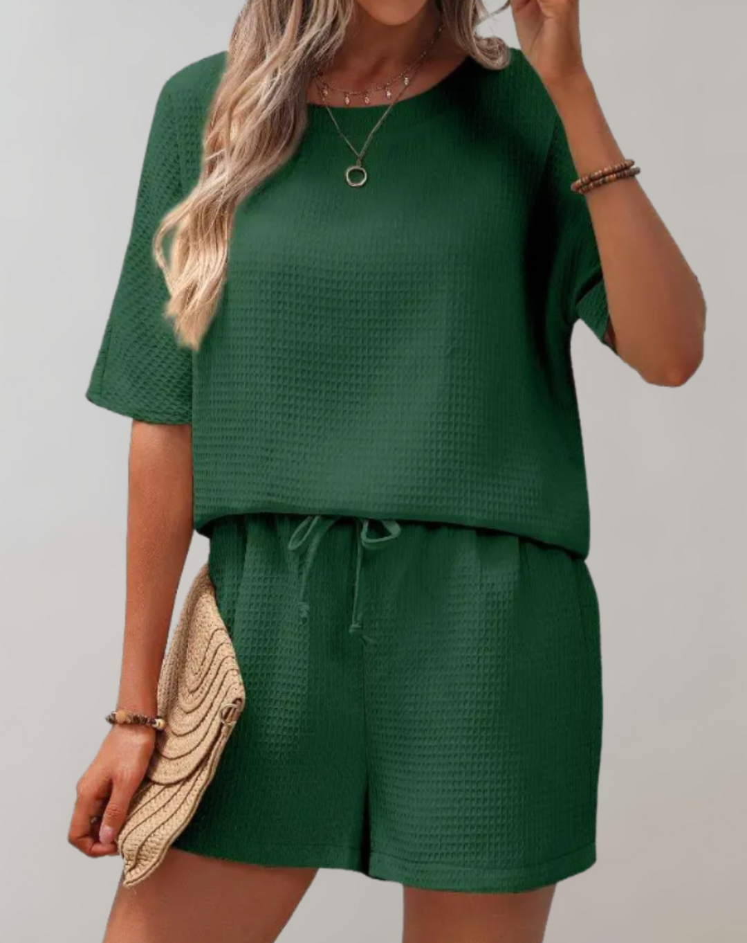 Chic women's two-piece set with a stylish top and loose-fit shorts, perfect for casual elegance and comfort.