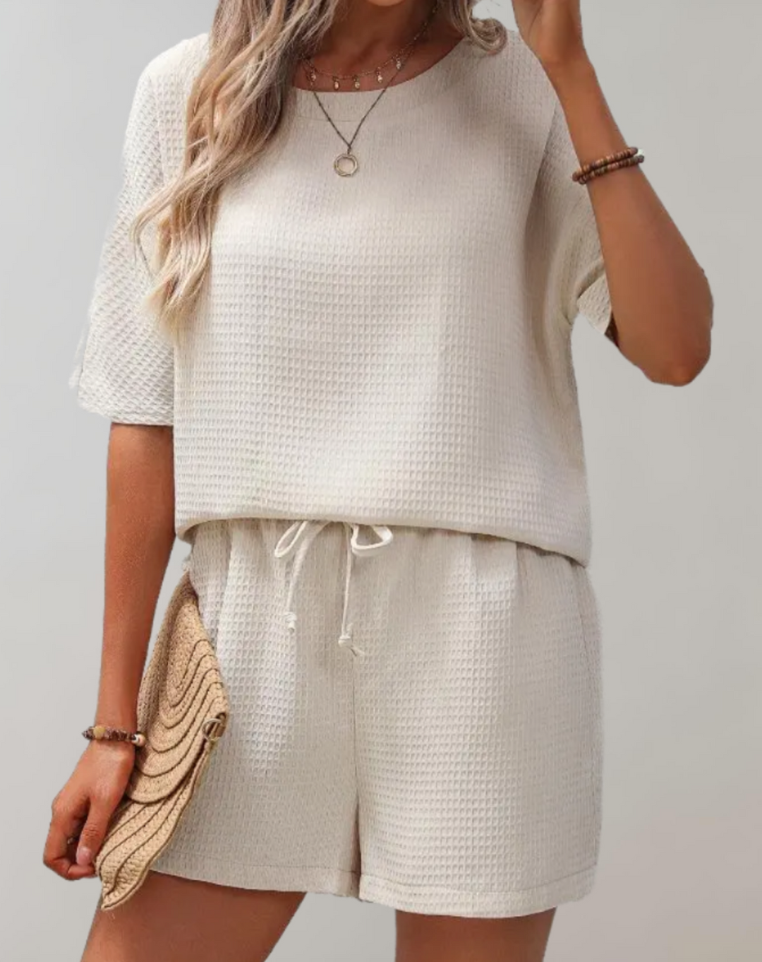 Chic women's two-piece set with a stylish top and loose-fit shorts, perfect for casual elegance and comfort.
