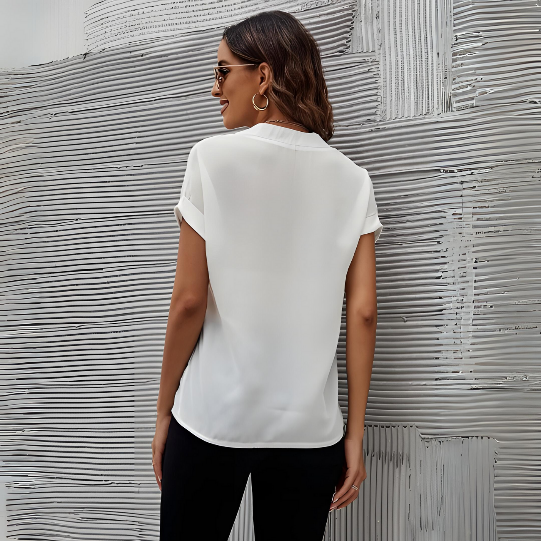Chic women's V-neck blouse in soft polyester-viscose, tailored fit, versatile for elegant day or night looks.