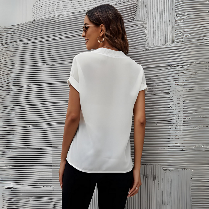 Chic women's V-neck blouse in soft polyester-viscose, tailored fit, versatile for elegant day or night looks.